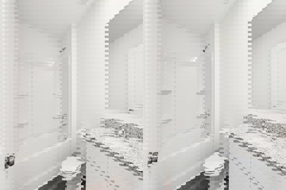 A bathroom with a tub sink and toilet.