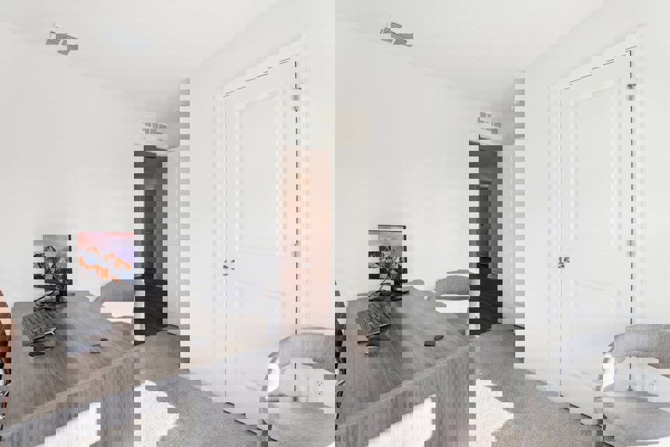 A room with a desk and a tv.