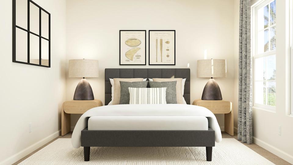 A room with a bed and lamps.