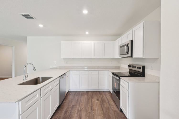 A kitchen with white cabinets.