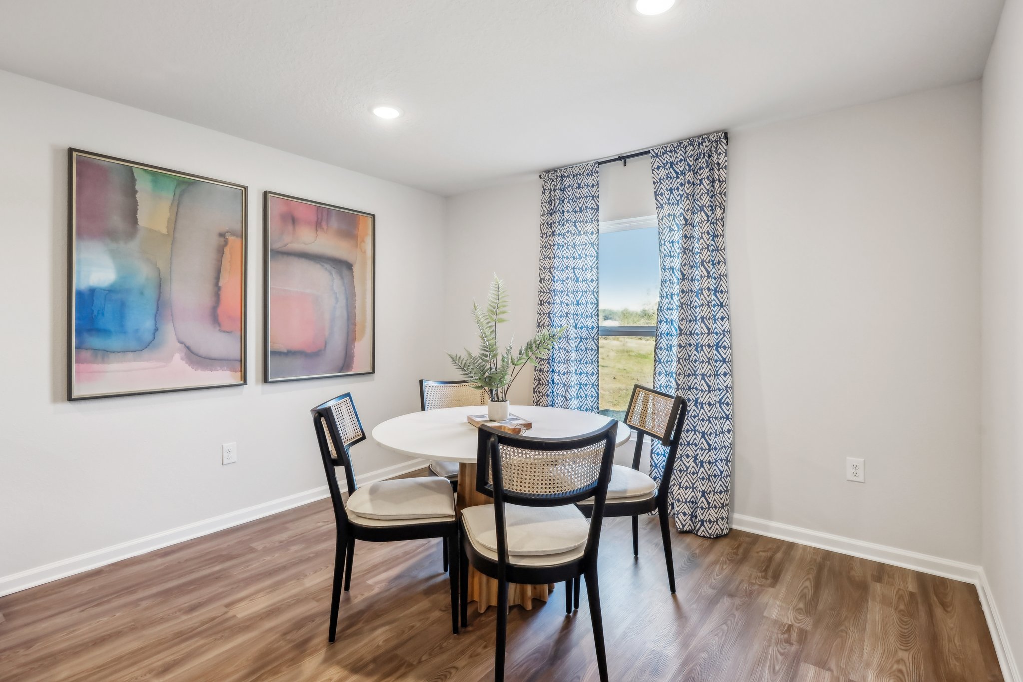 A dining room with a table and chairs.