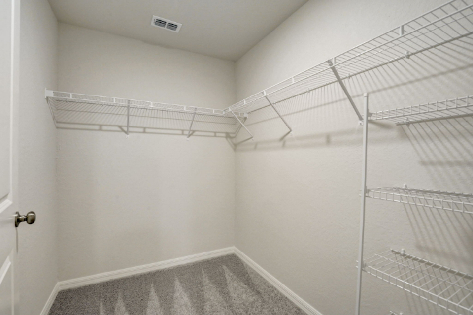 A white room with a metal rack.
