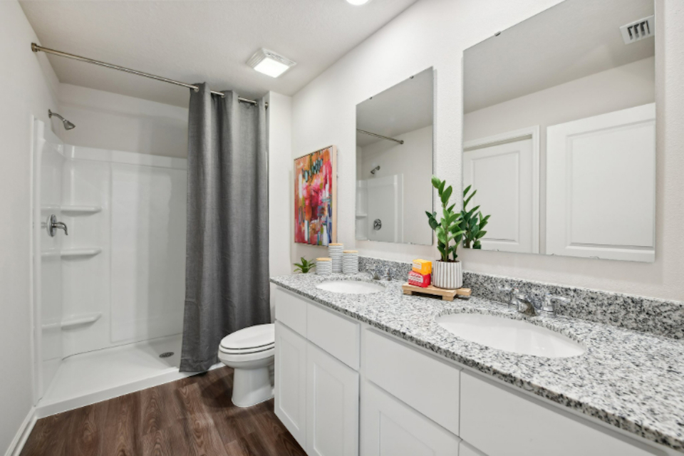 A bathroom with a tub sink and toilet.