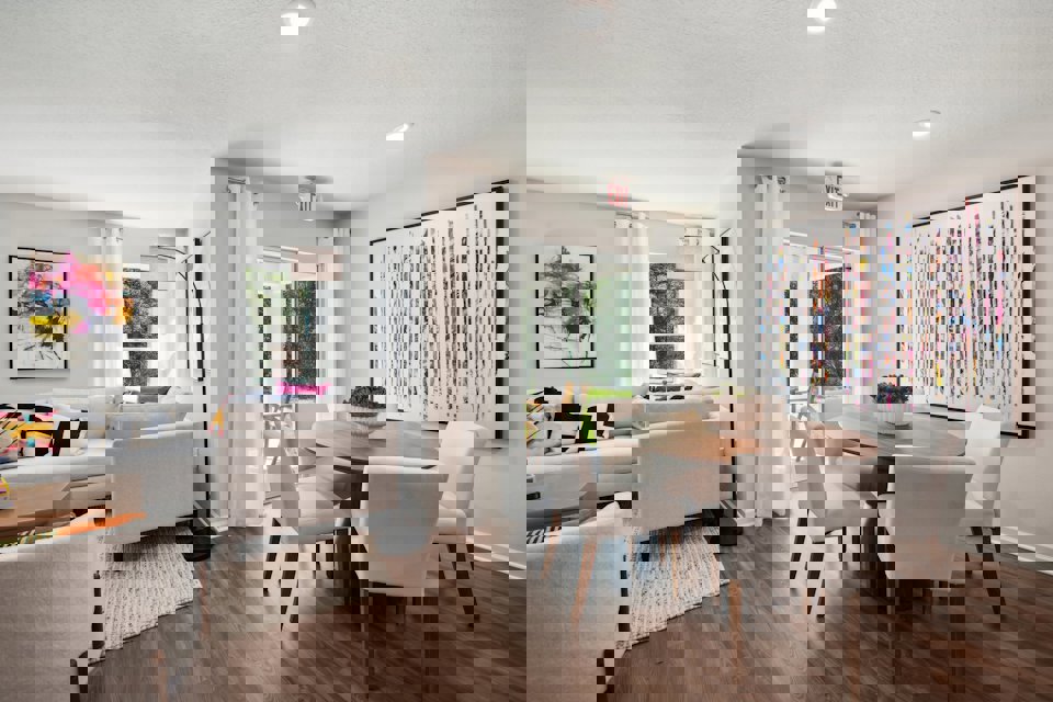 A living room with a table and chairs.