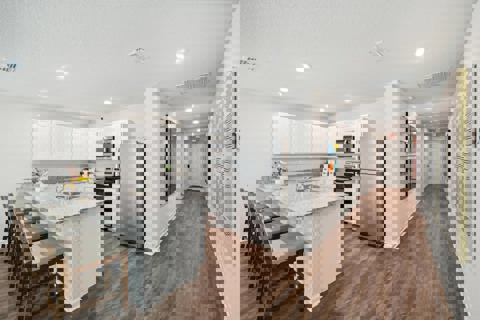 A kitchen with white cabinets.