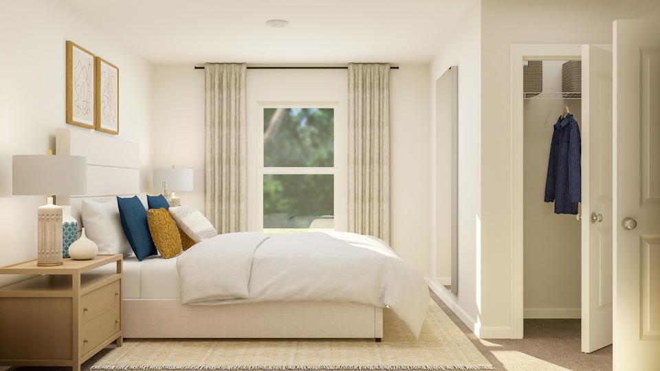 A bedroom with a bed and a window.