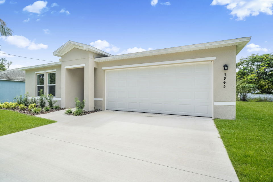 A white house with a garage.