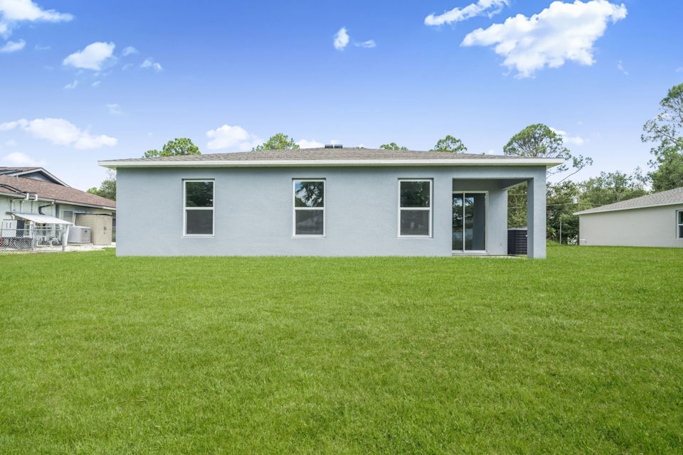 A house with a grass yard.