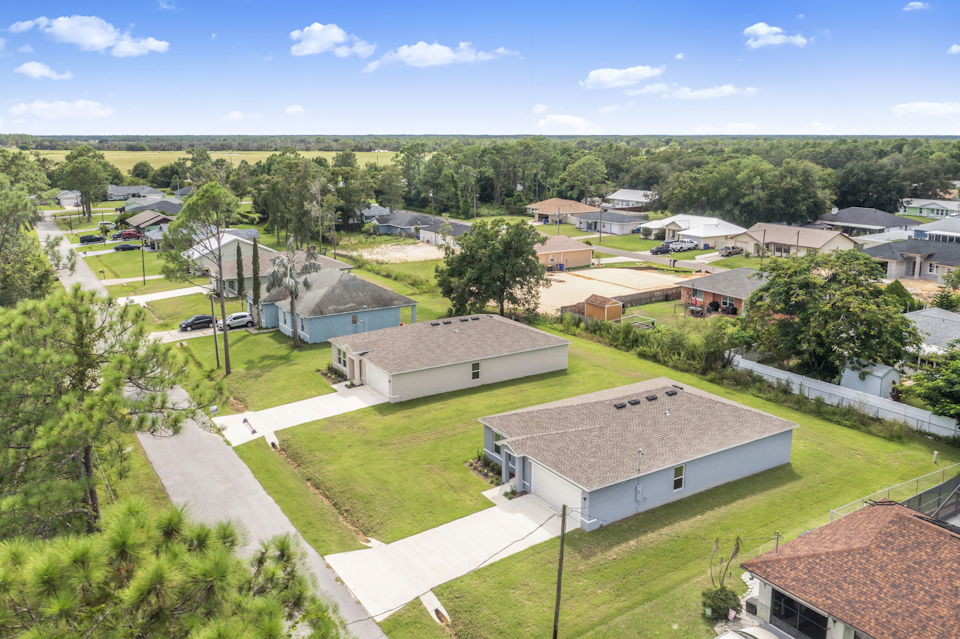 A group of houses with trees around them.