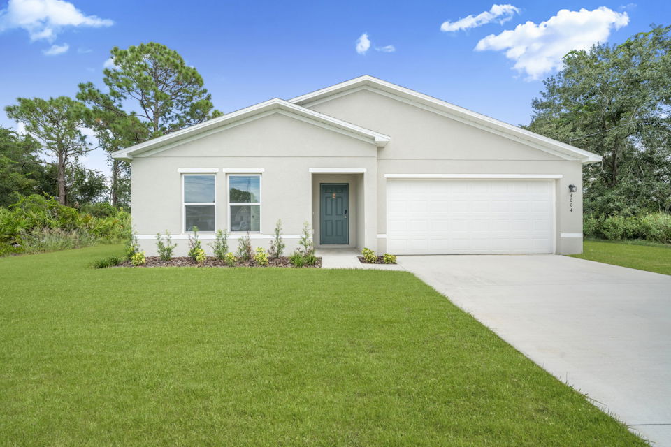 A white house with a driveway.