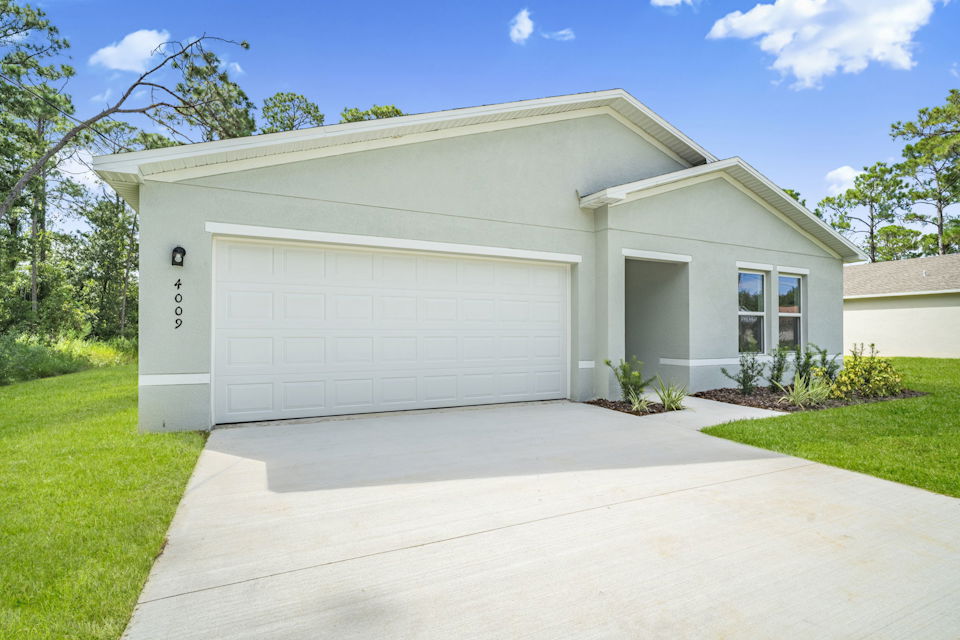 A white garage with a driveway.