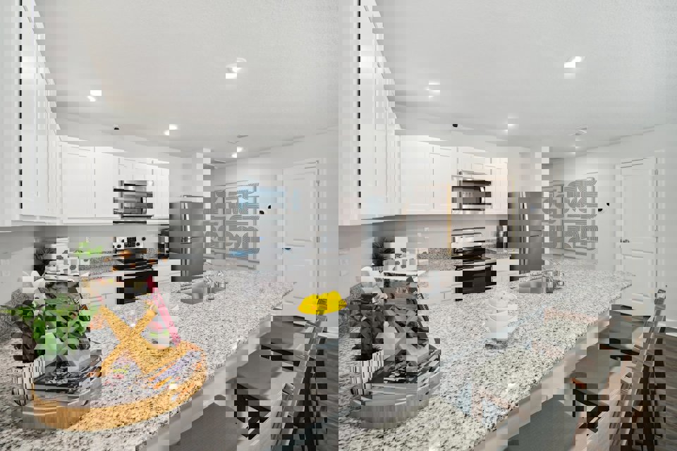 A kitchen with white cabinets.