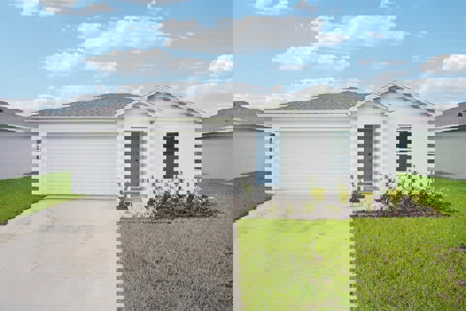 A white house with a garage.