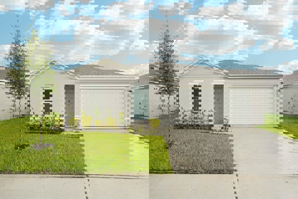 A white house with a garage.