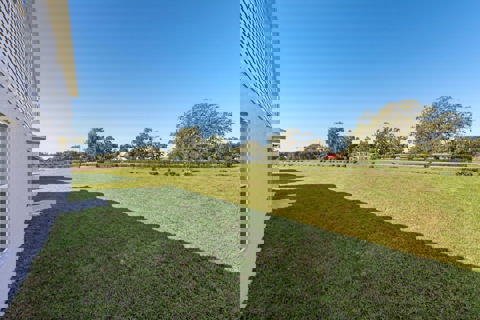 A grassy field next to a building.