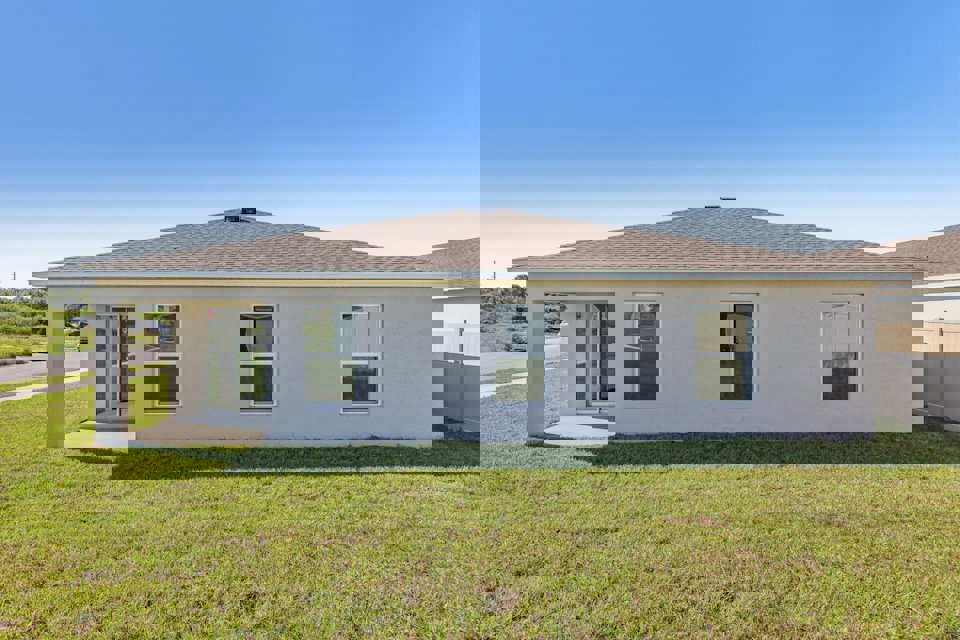 A house with a grass yard.