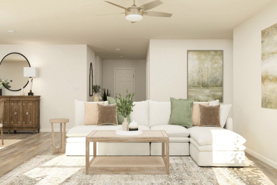 A living room with a white couch and a white table.