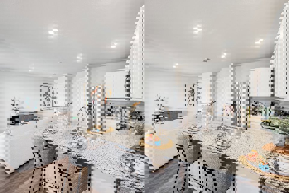 A kitchen with a marble counter top.