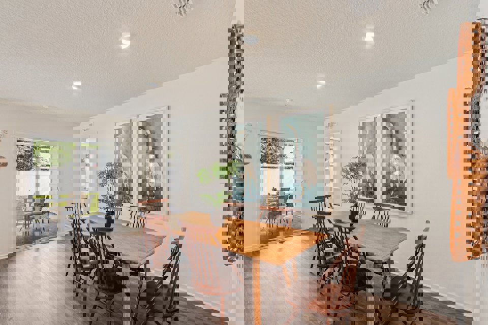 A dining room with a table and chairs.