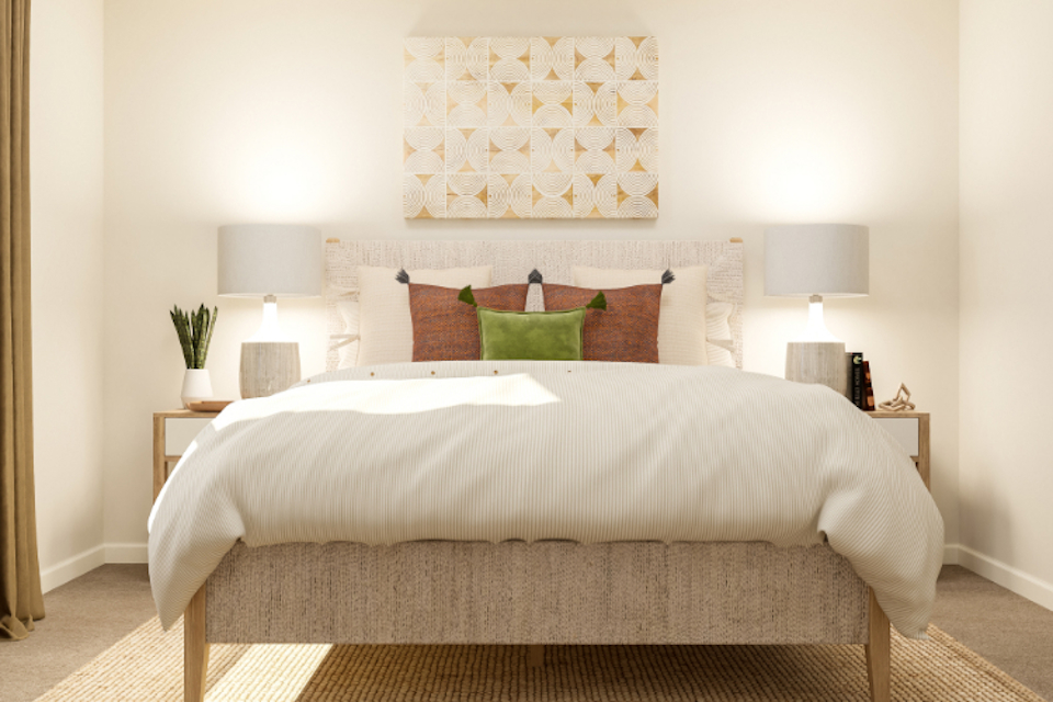 A bed with a white bed spread.