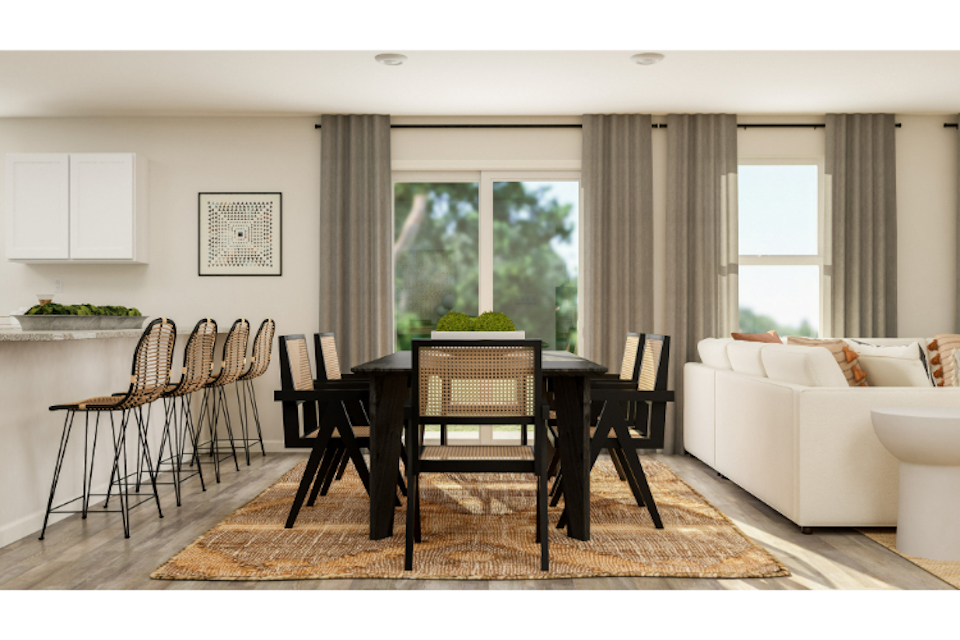 A living room with a table and chairs.
