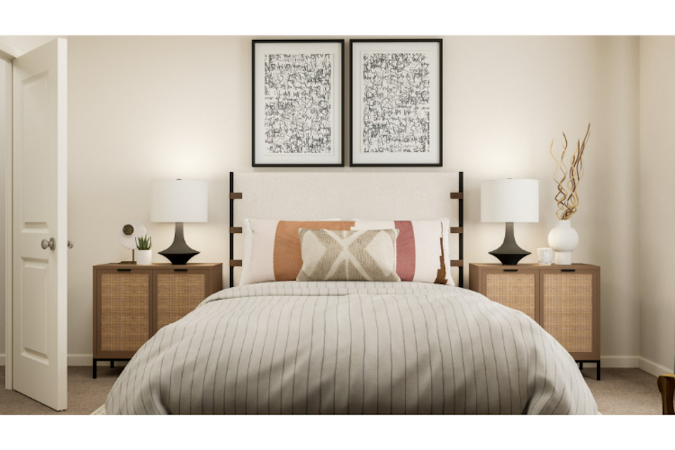 A bed with a white bed spread.