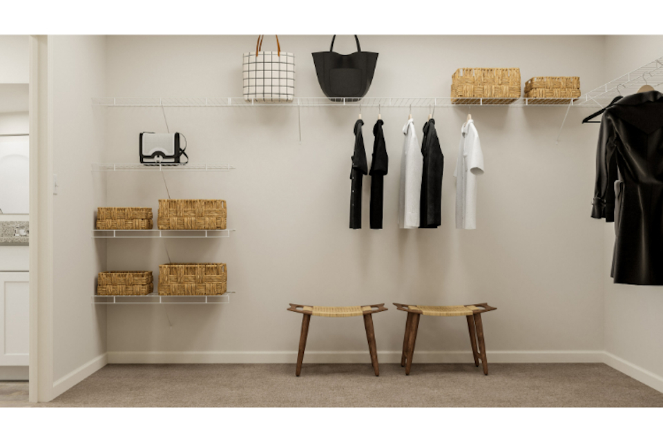 A room with a wall of clothes on the wall.