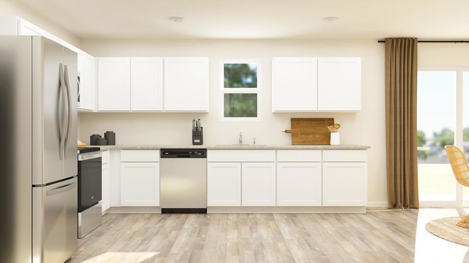 A kitchen with white cabinets.