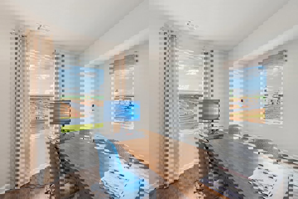 A room with a desk and a computer.