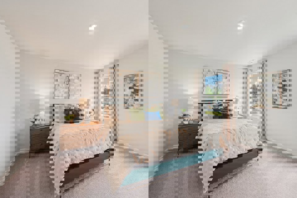 A bedroom with a bed and lamps.