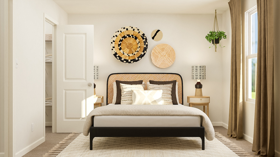 A bedroom with a bed and a lamp.