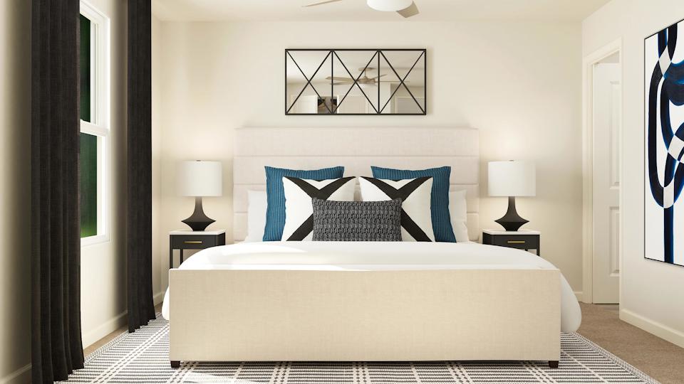 A bed with a blue and white striped blanket.