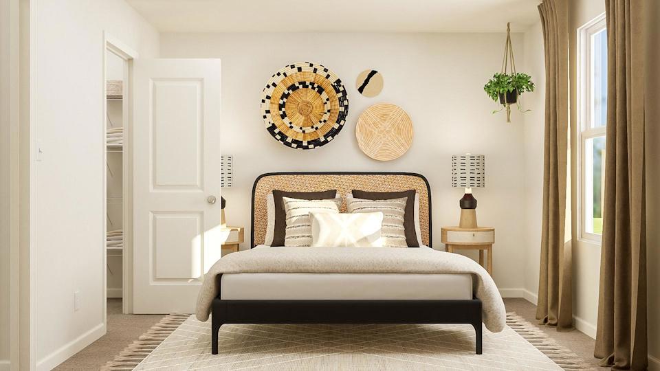 A bedroom with a bed and a lamp.