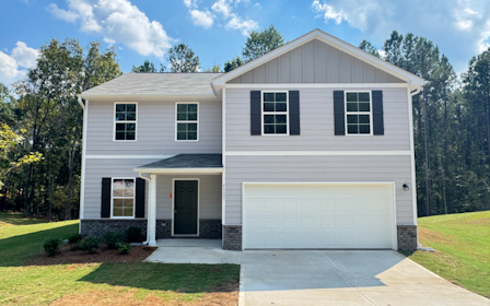 A white house with a garage.