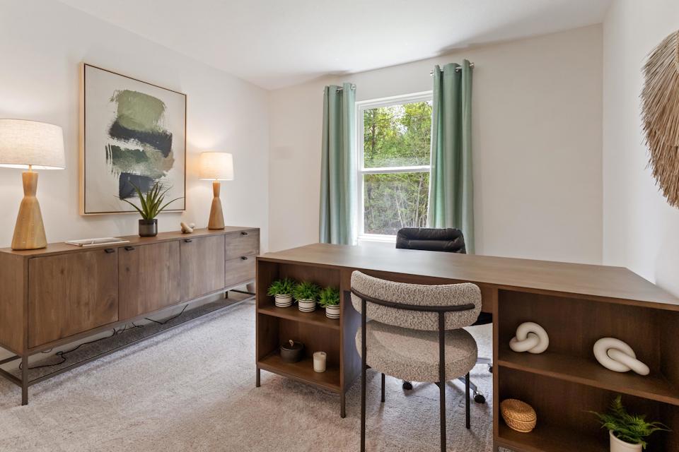 A room with a table and chairs.