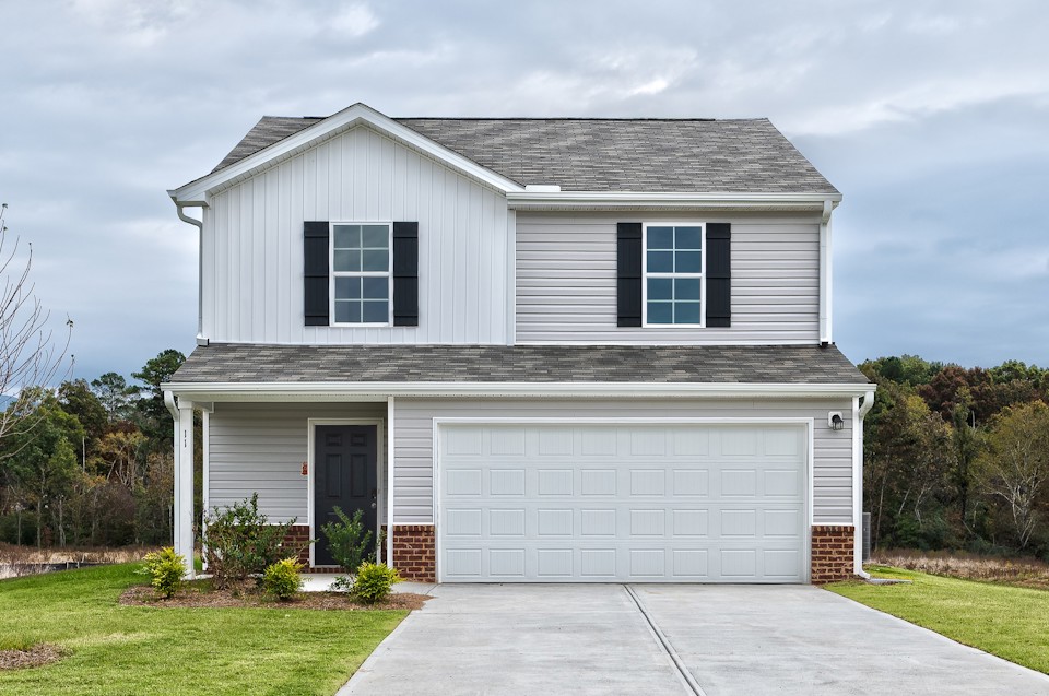 A white house with a garage.