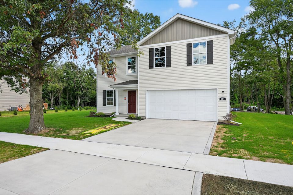 A white house with a garage.