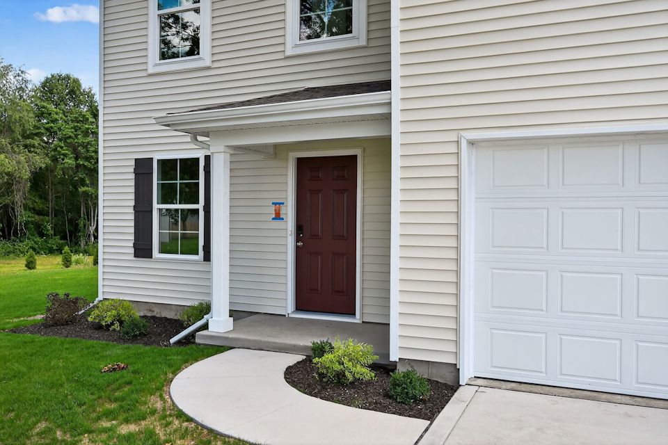 A house with a garage and a door.