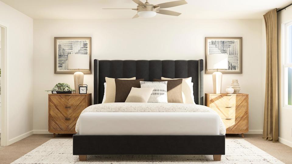 A bedroom with a bed and a fan.