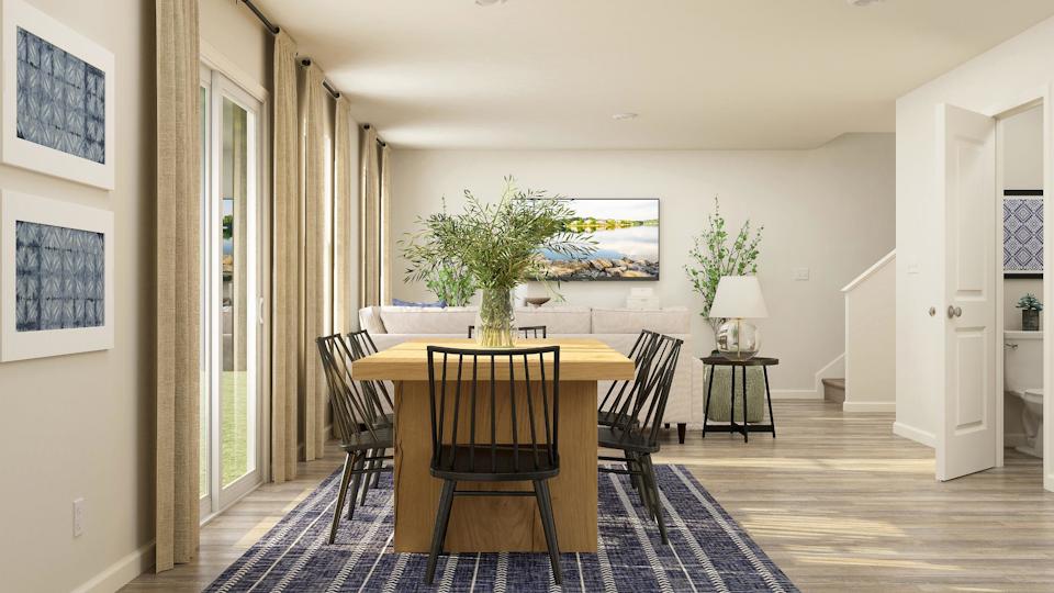 A dining room with a table and chairs.
