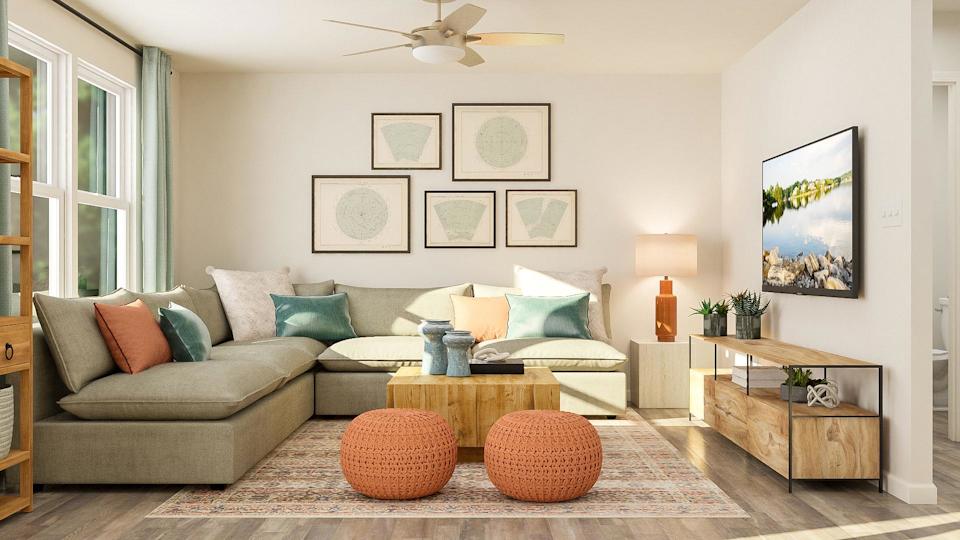 A living room with a couch and a fan.
