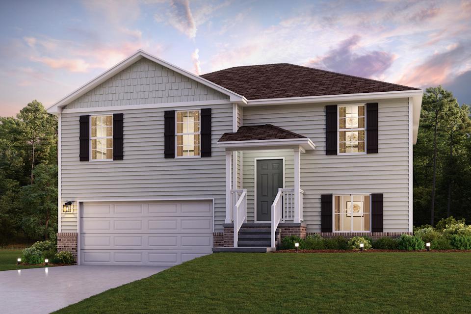 A white house with a green lawn.