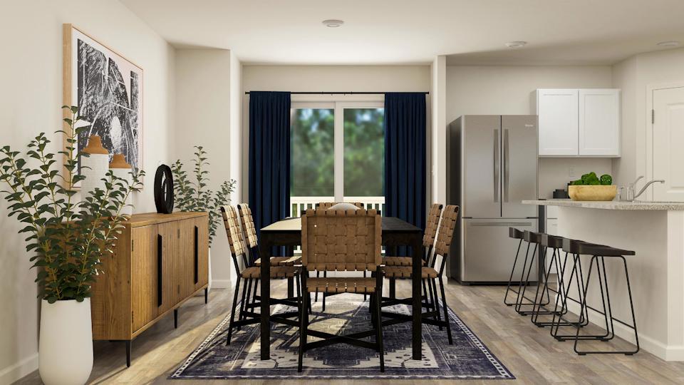 A kitchen with a dining table and chairs.