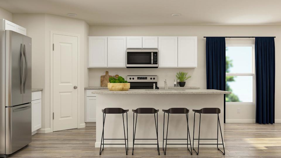 A kitchen with white cabinets.