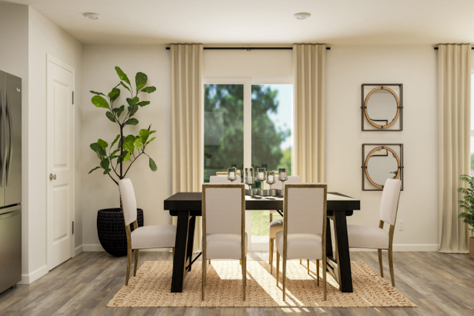 A dining room with a table and chairs.
