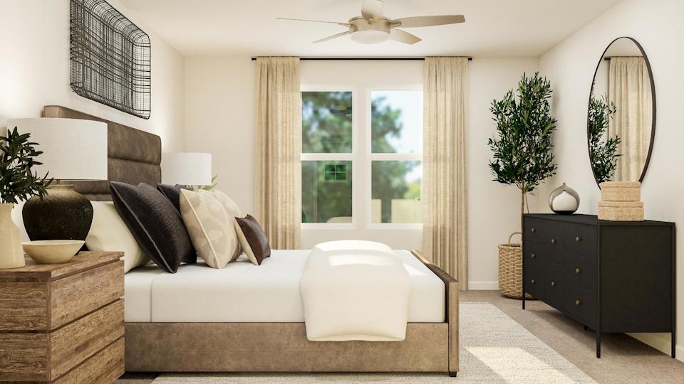 A living room with a couch and a mirror.