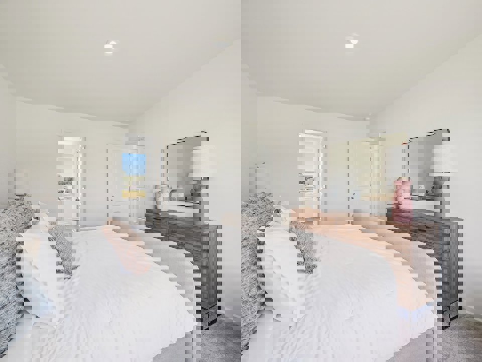 A bedroom with a bed and a mirror.