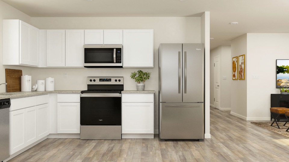 A kitchen with white cabinets.