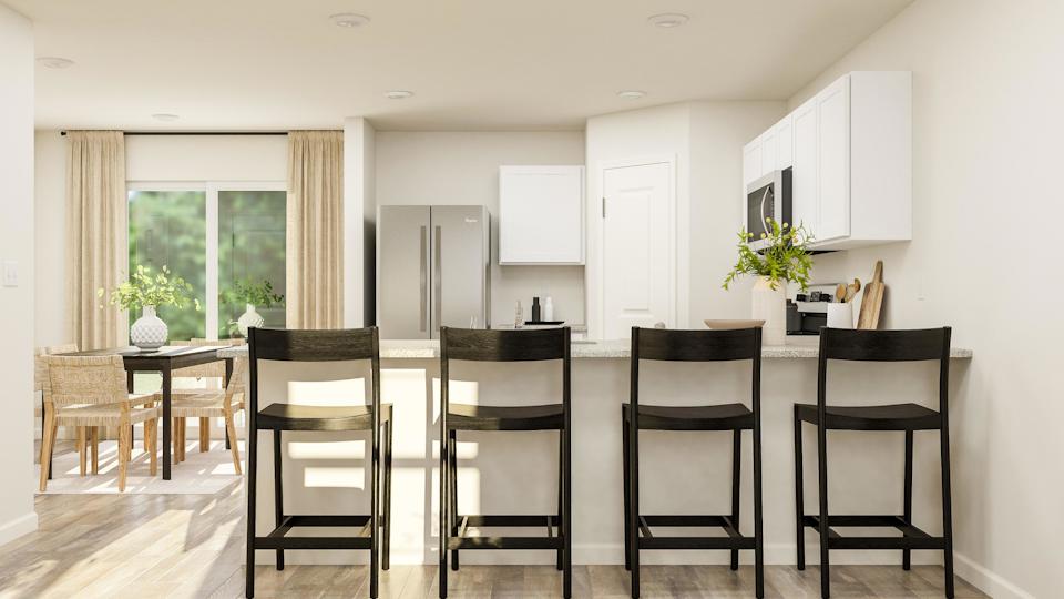 A kitchen with a dining table and chairs.