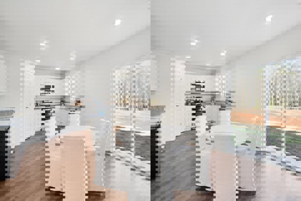 A large kitchen with a dining table and chairs.